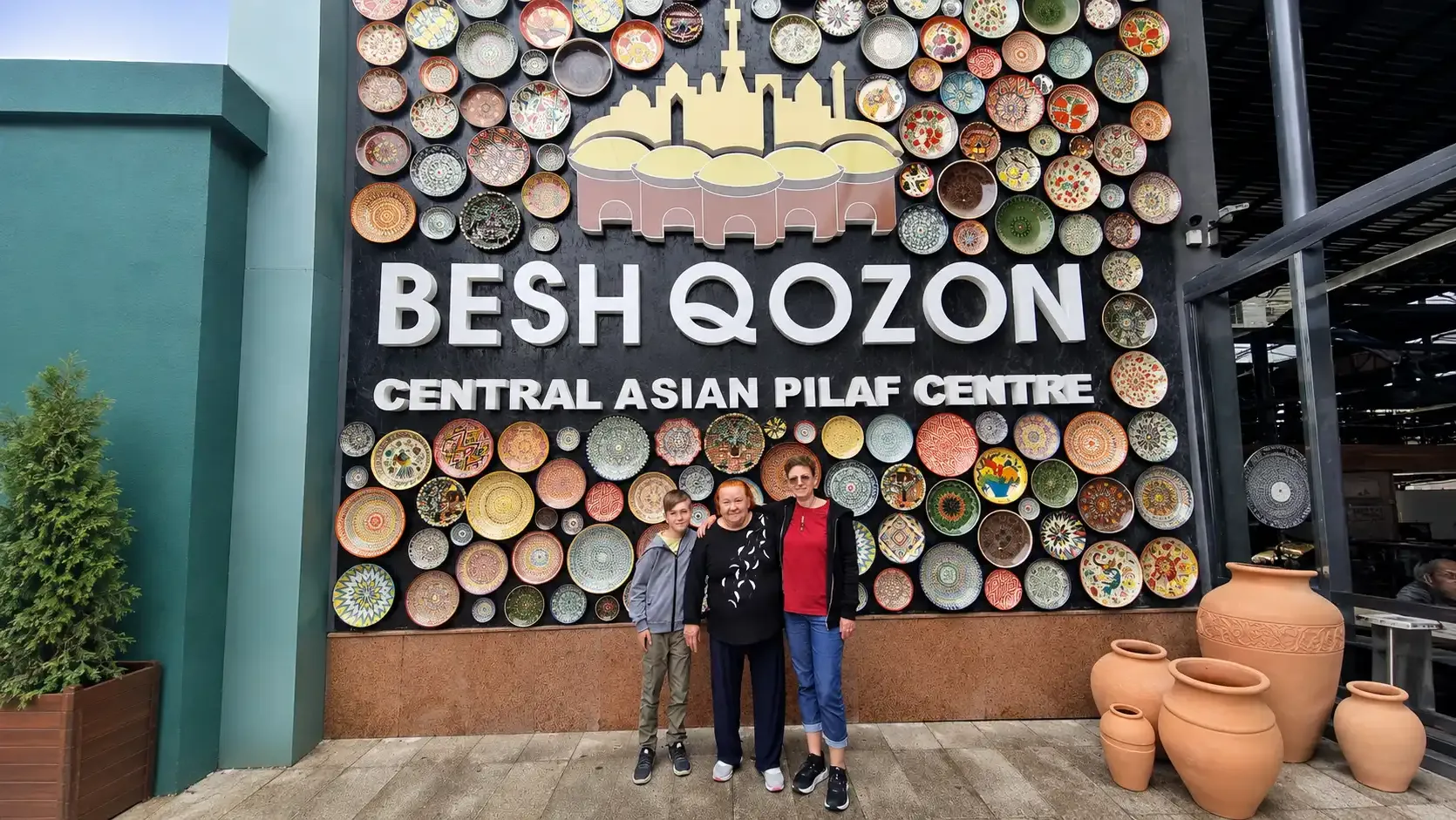 The ceramic-plate wall and sign of the Besh Qozon Central Asian Pilaf Centre.